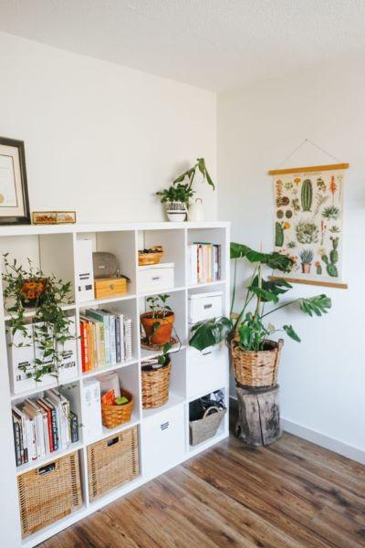 A white shelving unit with plants in baskets

Description automatically generated