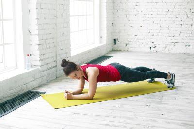 A person doing plank on a mat

Description automatically generated